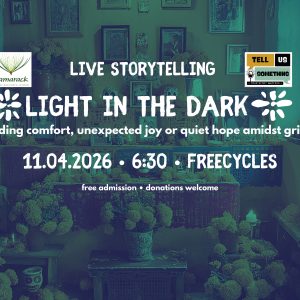 This promotional flyer announces a live storytelling event with the following key details:Event Title: LIVE STORYTELLING – LIGHT IN THE DARK Theme: "finding comfort, unexpected joy or quiet hope amidst grief" Date & Time: November 4, 2026 (11.04.2026) at 6:30 PM Location: Freecycles Admission: Free admission (donations are welcome) Organizers / Logos:Tamarack Grief Resource Center logo (top-left) Tell Us Something logo featuring the tagline "Your Story Matters" (top-right) Visual Background:The image features a teal/green-toned background photograph depicting an altar or memorial space filled with flowers, candles, framed pictures, and decorative objects.